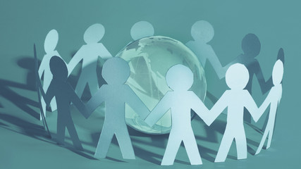 Team of paper doll people holding in hands