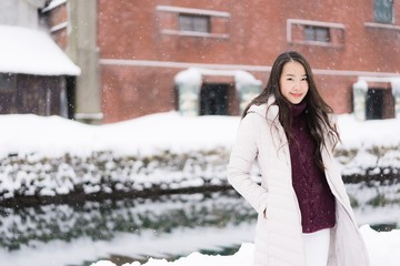 Beautiful young asian woman smile and happy with travel trip in Otaru canal Hokkaido Japan
