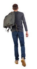 Fototapeta premium back view of walking man with green bag.