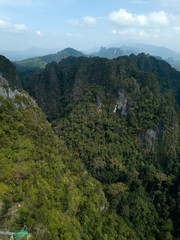 Aerial view of green nature and rocks near TIger Cave Temple in Krabi, Thailand. Photo from drone.