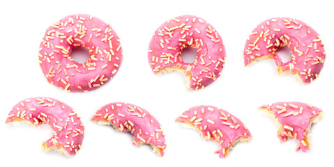 pink donut biting on white background - obrazy, fototapety, plakaty
