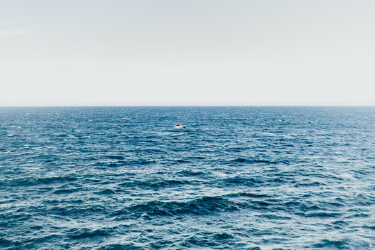 Waves in a turbulent and powerful sea, a windy day. Color blue.