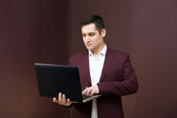 Young successful businessman with a laptop in hand.