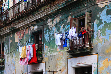 Hanging laundry to dry on balcony in Havana