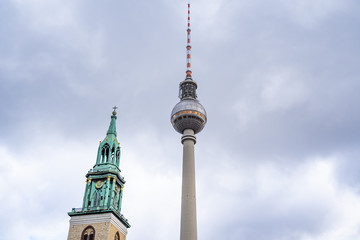 tv tower Berlin isolated on natural blue sky background, The TV Tower located on the Alexanderplatz in Berlin, Germany, tv tower with the st. Mary church in berlin