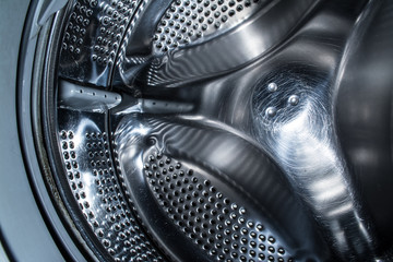 Clean drum of a modern washing machine close up.