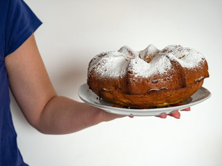 Cupcake with white powder in the hands of a girl