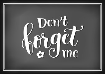 Calligraphy lettering of Dont forget me in white on chalkboard background with forget me not flowers for decoration, poster, banner, greeting card, letter, gift tag, present