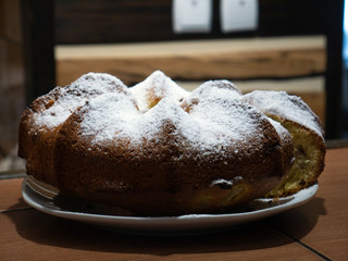 Cupcake with white powder in the hands of a girl