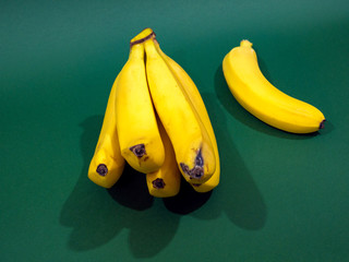 A bunch of bananas on a green background