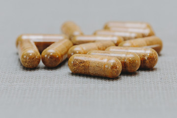 Capsules with brown vitamins front view