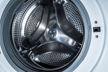 Clean drum of a modern washing machine close up.