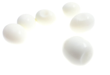 Peeled boiled eggs on a white background