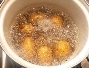 Potatoes are cooked in a pan in the kitchen