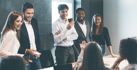 Business colleagues having break and talking after meeting