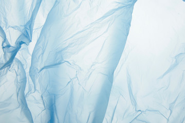 Light blue plastic garbage bag material as a background