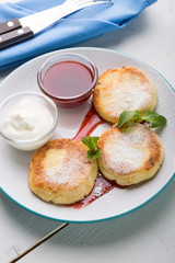 Fritters served with jam and cream for breakfast
