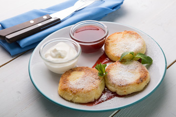 Fritters served with jam and cream for breakfast