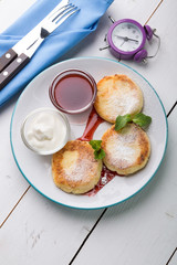 Fritters served with jam and cream for breakfast