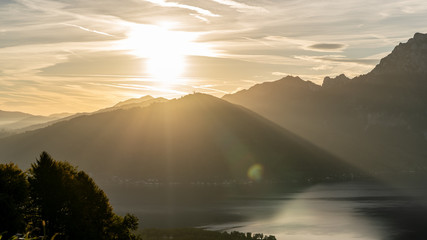 great sunrise behind a huge mountain in Austria with a amazing lake in the foreground, amazing...