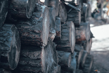 Natural wooden background - closeup of chopped firewood. Firewood stacked and prepared for winter Pile of wood logs