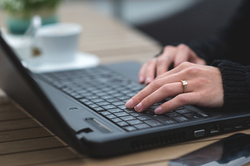 Close-Up Of Hands Using Laptop