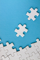 White jigsaw puzzle pieces on blue background