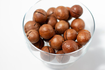 Macadamia nuts on white background close up