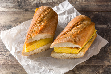 Bocadillo de tortilla española. Spanish potato omelette sandwich on wooden table