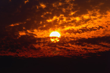 Big sun on dark cloud