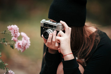 beautiful woman with a retro camera on a black background