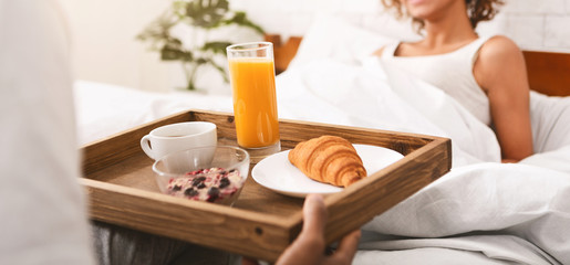 Boyfriend bring some breakfast to his girlfriend in bed