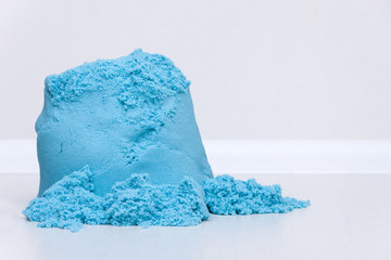 Kids education  kinetic sand on the white background. Copy space