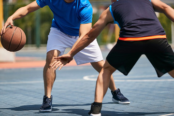 young asian men playing basketball