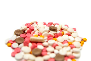 Colored pills and tablets on a white background