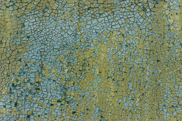 Old wall covered with cracked green and blue paint. For design, banner and layout