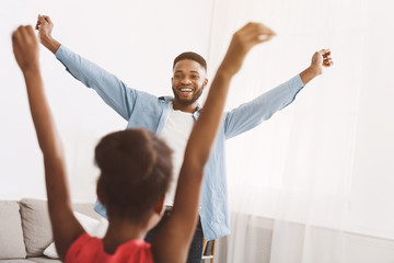 Fototapeta premium Little girl having fun with father at home