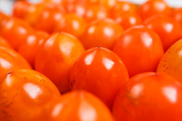 Fresh ripe persimmons in market. Persimmons background.