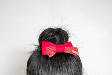 Hairstyle - bun with red bow