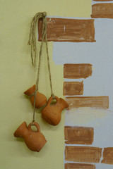 Styled old Russian interior, earthenware jugs hanging on the ropes on the wall