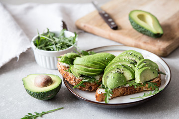 healthy breakfast with avocado and Delicious wholewheat toast. sliced avocado on toast bread with spices. Mexican cuisine - obrazy, fototapety, plakaty