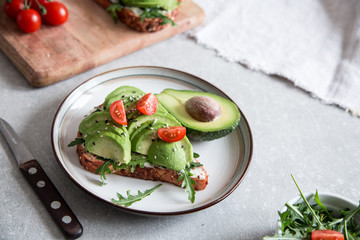 healthy breakfast with avocado and Delicious wholewheat toast. sliced avocado on toast bread with spices. Mexican cuisine