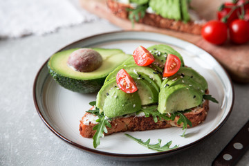 healthy breakfast with avocado and Delicious wholewheat toast. sliced avocado on toast bread with spices. Mexican cuisine