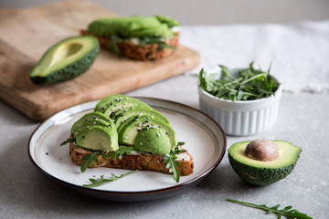 healthy breakfast with avocado and Delicious wholewheat toast. sliced avocado on toast bread with spices. Mexican cuisine