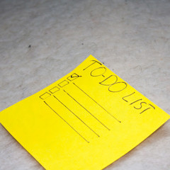 Yellow note paper. To do list on gray  background