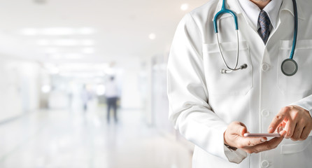 Male doctor using mobile phone at hospital. Medical healthcare and doctor service.