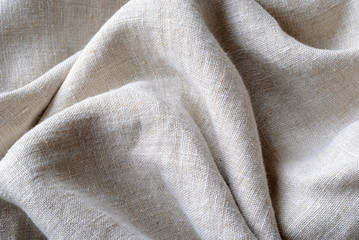 Gathered and folded texture of woven linen fabric