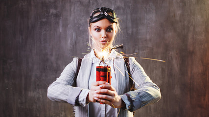 Energetic young female leader with explosives and jetpack behind