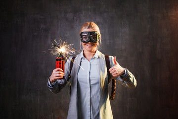 Energetic young female leader with explosives and jetpack behind