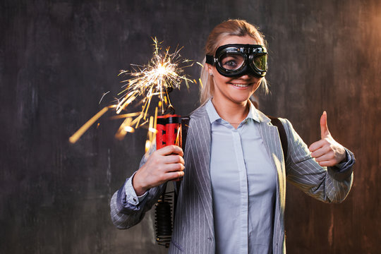 Energetic young female leader with explosives and jetpack behind